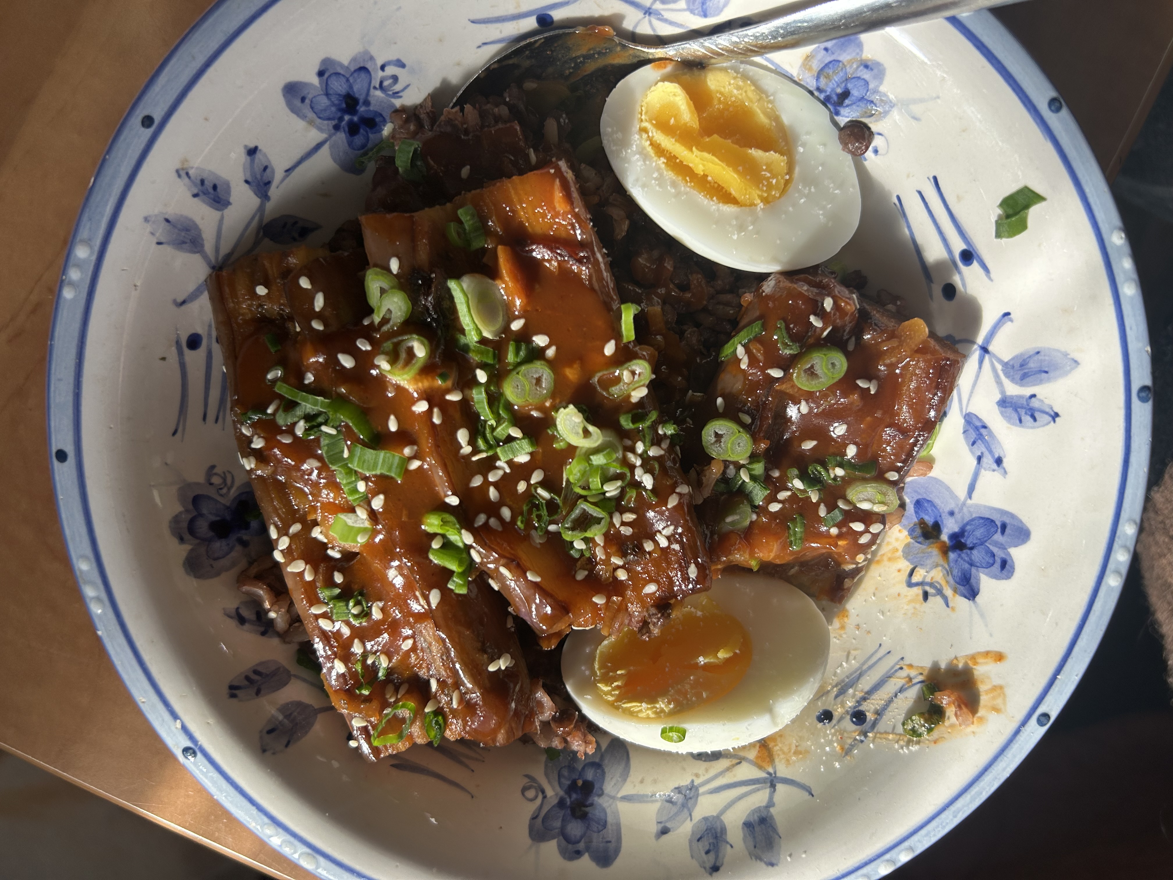 Braised eggplant with an egg over lentils and rice